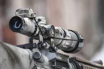 Rifle scope on the street with blurry background.