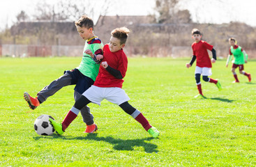 Boys play soccer sports field