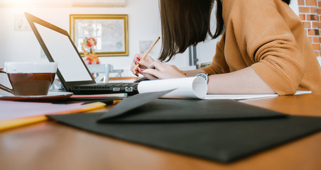 Businesswoman using laptop to searching information and working online in office