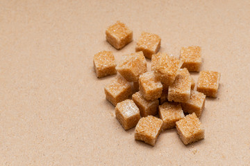 brown refined sugar cubes on craft paper background