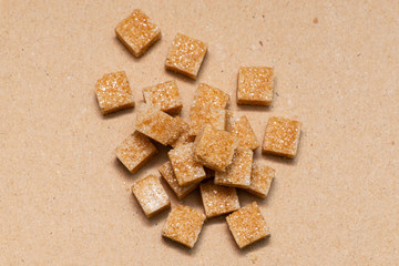 brown refined sugar cubes on craft paper background