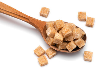 brown refined sugar in a wooden spoon on a white background