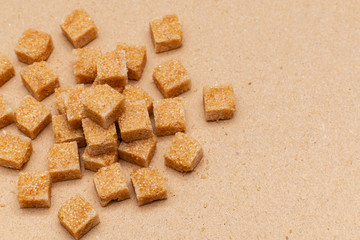 brown refined sugar cubes on craft paper background
