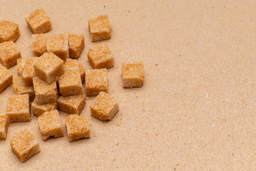brown refined sugar cubes on craft paper background