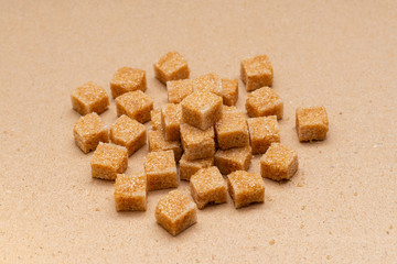 brown refined sugar cubes on craft paper background
