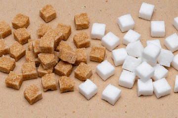 brown and white refined sugar cubes on craft paper background