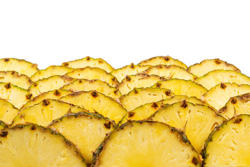 Naklejka na ściany i meble Pineapple juicy yellow slices background. Top view.
