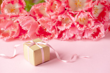 Present or gift box with Beautiful bouquet of pink tulips flowers on pink background. Card Concept for Mothers day, 8 March, Happy Birthday