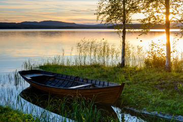 Naklejka na ściany i meble Boat at the lakeside at sunset, Solleron, Dalarna, Sweden