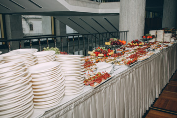 a lot of cold snacks and drinks on buffet table, catering