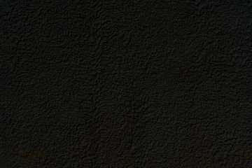 Abstract black background. Black stucco texture. Dark rough surface.