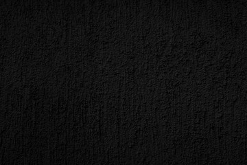 Abstract black background. Black stucco texture. Dark rough surface.