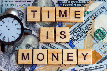 Words Time is Money as a proverb on dollar usa background with black and white clock.