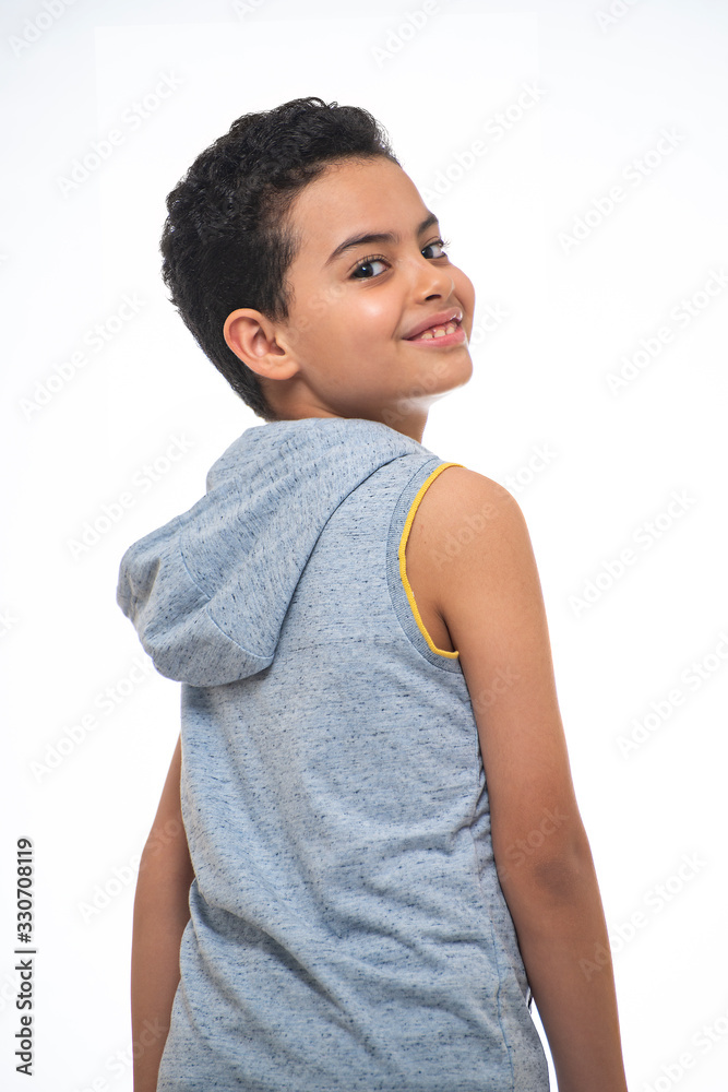 Wall mural portrait of young smiling boy looking backwards