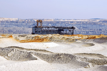 Fototapeta premium Sand dunes made by excavator. An interesting sight from a coal mine. Beautiful geological structures on open pit coal mine. 