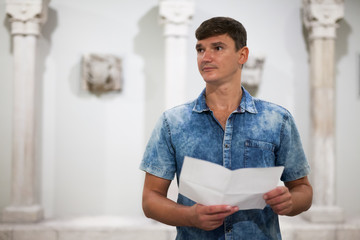 Man visiting museum with leaflet