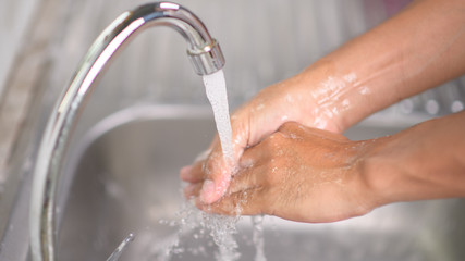 Hygiene concept. Washing hands with soap under the faucet with water