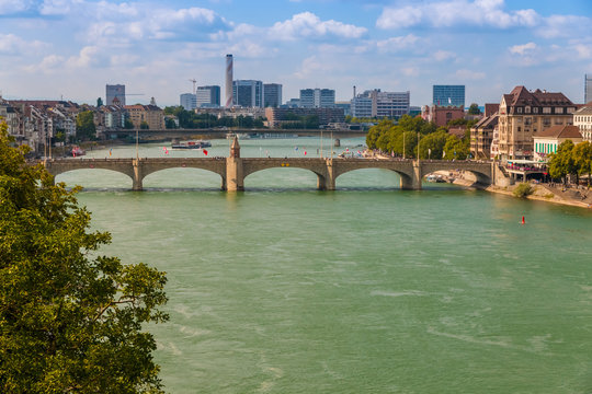Nice view of the Rhine river with the Middle Rhine Bridge and the industrial area in the background. The bridge connects the main section of Basel called Grossbasel with Kleinbasel on the right bank.