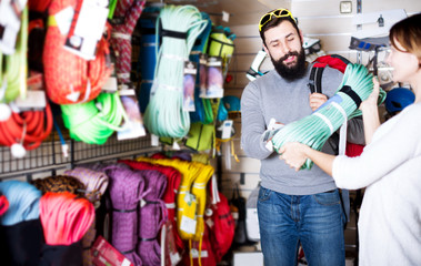 Couple deciding on climbing equipment