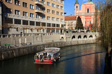 Lubiana / Slovenia - December 8, 2017: View of Lubiana river with a tourist boat, Lubiana, Slovenia