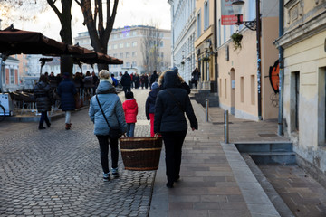 Lubiana / Slovenia - December 8, 2017: Tourist carry a basket in Lubiana town, Slovenia
