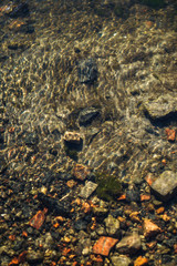 Stream in nature with the ruins of buildings and waste. Flooded building materials after the flood. Background with water for design