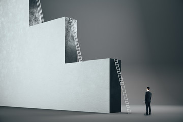 Businessman looking on big ladder