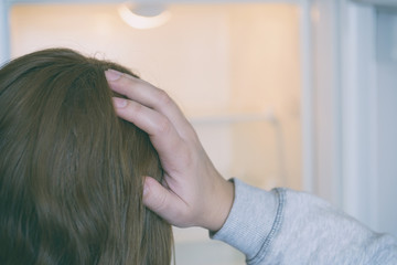 Naklejka premium Worried woman looking at empty refrigerator