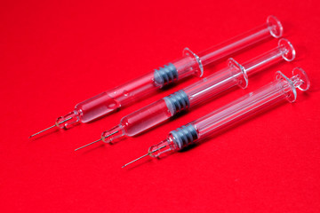 Syringes isolated on red background