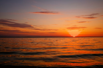 Beautiful colorful sunset on the sea coast. Nice scene with sunrise over water