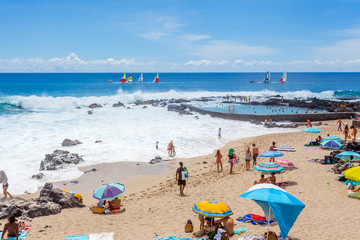 beach with umbrellas and chaise lounges, Reunion island 