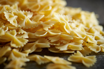 Dried farfalle short pasta background 