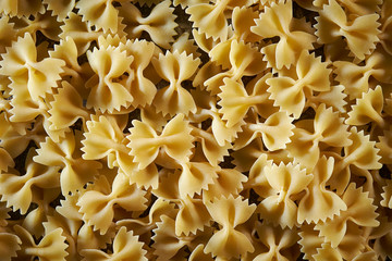 Dried farfalle short pasta background 