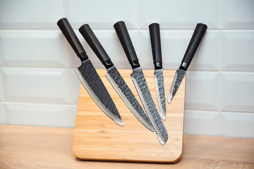 Set of knives for kitchen. Modern kitchen knives on a table.