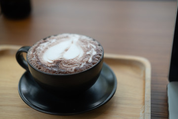 Hot chocolate latte art in black cup