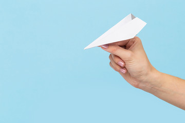 Hands holding the sign of paper airplane or message on blue studio background. Negative space, advertising. Social media, showing meaning, communication, gadgets, modern technologies.