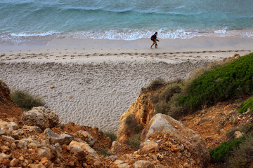 Sant Tomas, Menorca / Spain - June 25, 2016: A tourist walking in Binigaus beach, Sant Tomas, Menorca, Balearic Islands, Spain