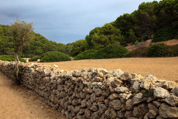 Sant Tomas, Menorca / Spain - June 25, 2016: A dry rock wall near Binigaus beach, Sant Tomas,...