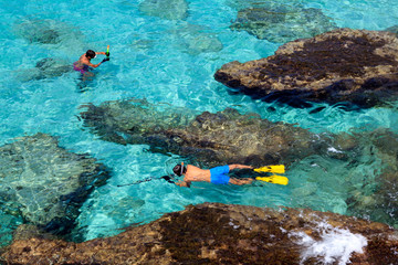 Es Migjorn Gran, Menorca / Spain - June 25, 2016: Clear water and snorkelers at Escorxada beach, Es...