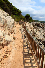 Fototapeta na wymiar Es Migjorn Gran, Menorca / Spain - June 25, 2016: The trail to Escorxada beach, Es Migjorn Gran, Menorca, Balearic Islands, Spain
