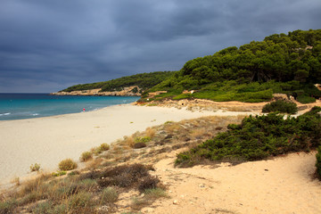 Sant Tomas, Menorca / Spain - June 25, 2016: The Binigaus beach with flowers, Sant Tomas, Menorca, Balearic Islands, Spain