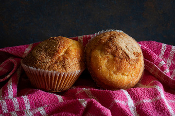 HOME CUPCAKES ON RED KITCHEN CLOTH AND BLACK BACKGROUND