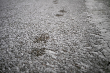 Fresh boot tracks on the snow -covered road in the evening