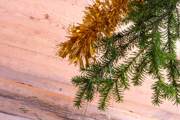 Christmas composition and Christmas, place for your text, decoration of a sprig of a Christmas tree and tinsel, on a whitewashed wooden background.