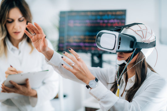 Doctor in Neuroscience Lab with Female Patient Wearing VR or Virtual Reality Goggles