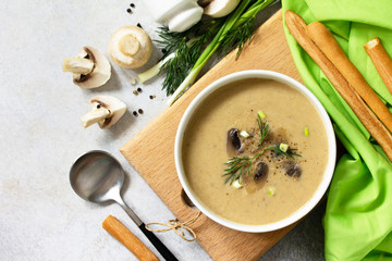 Vegan and diet healthy food. Mushroom soup puree with cream, champignons and vegetables. Top view flat lay.