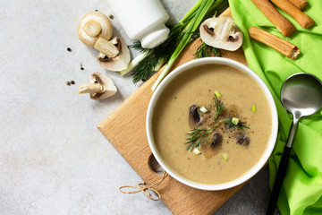 Vegan and diet healthy food. Mushroom soup puree with cream, champignons and vegetables. Top view flat lay.
