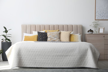 Stylish interior of contemporary room with comfortable bed