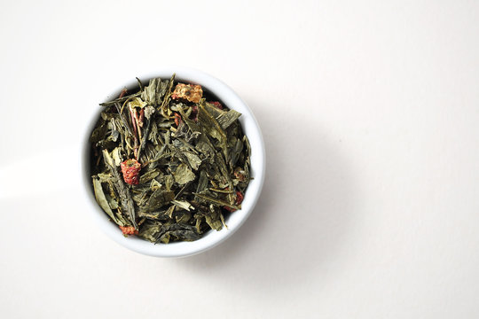 Green tea sencha with strawberries. Green tea with fruit. Top view, white background, isolated