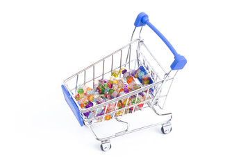 shopping cart with beads of multi-colored gemstones on a white background. isolate